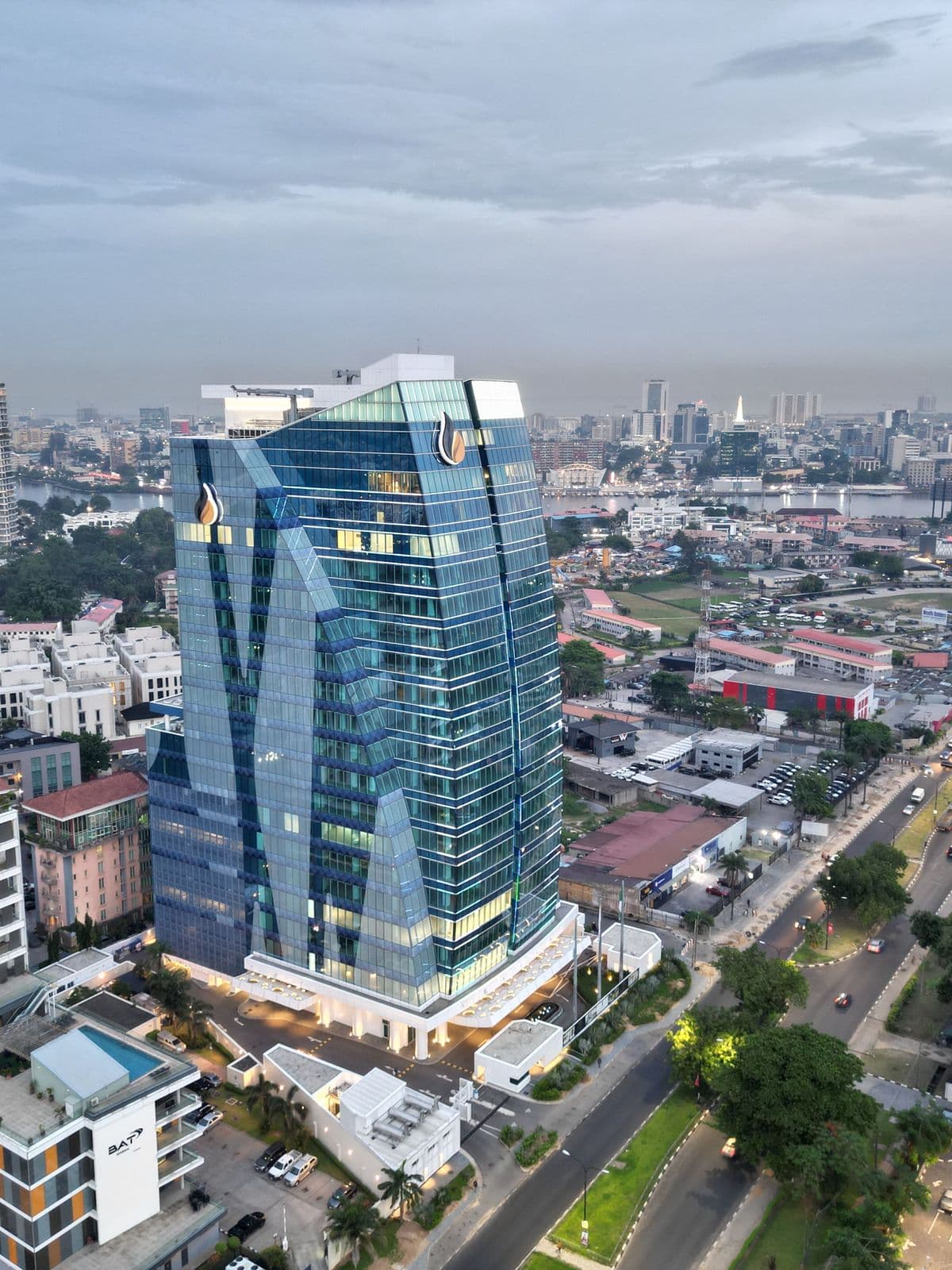 Contemporary glass tower above a city skyline